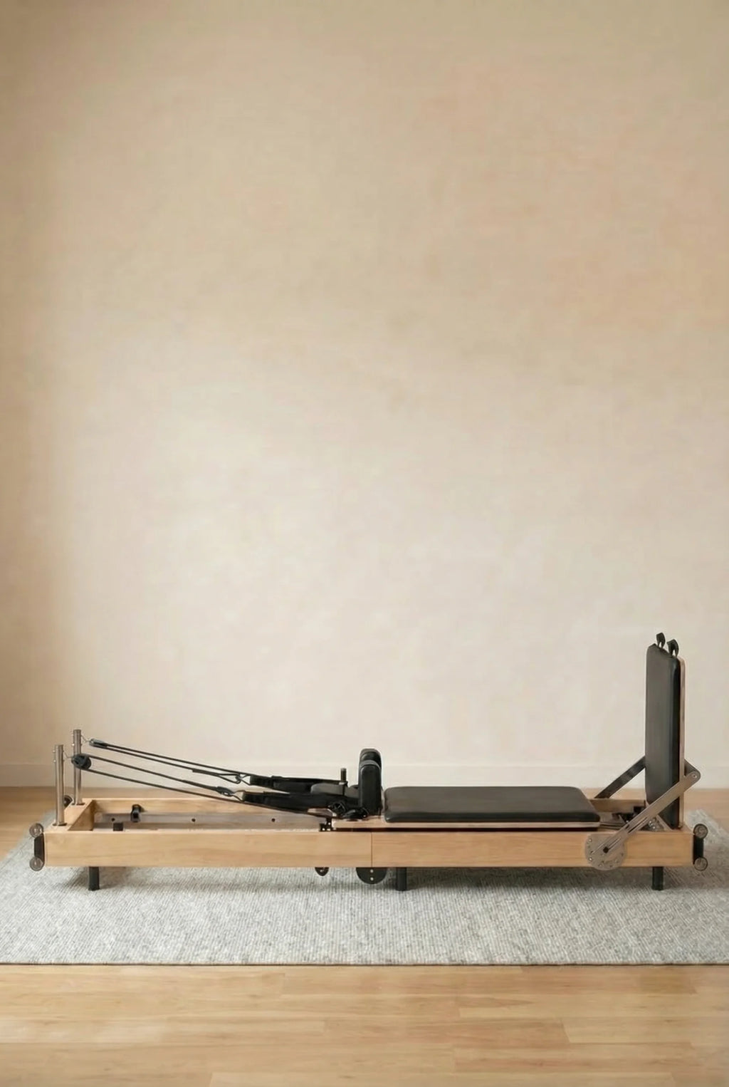 Moko Pilates reformer folded vertically for compact bedroom storage