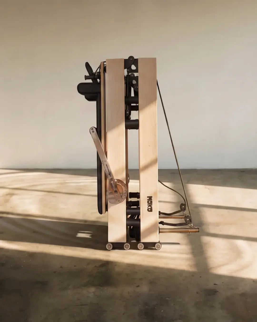 Space-saving foldable Pilates reformer in the folded position.